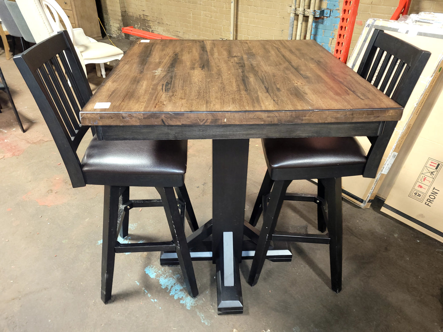 Peighton collection 42" high pub table paired with three swivel stools